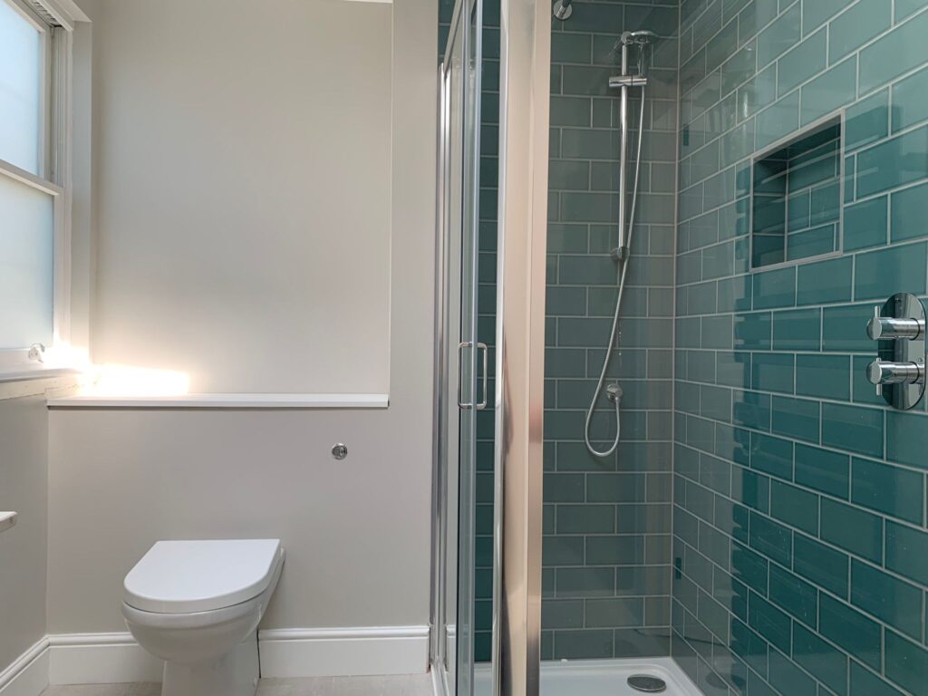 Minimalist bathroom with blue tiling