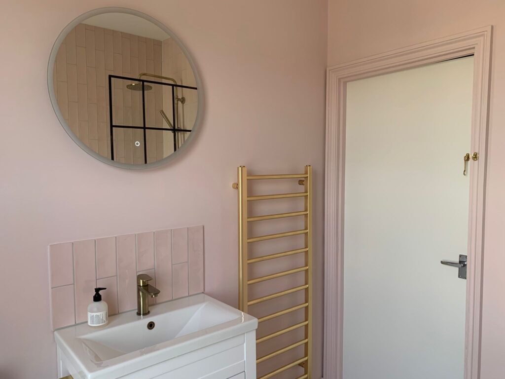 Modern simple rose pink bathroom with small white basin