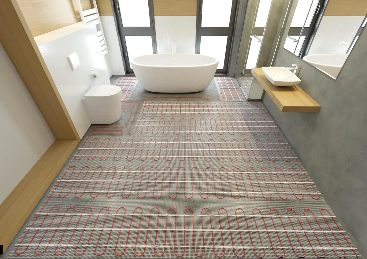 Electric underfloor heating installed beneath floor tiles during a modern bathroom renovation.